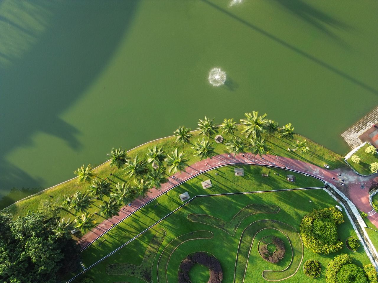 Crafting Captivating Headlines: Your awesome post title goes here Discover the vibrant greenery and serene water features of a Cheras park from above.